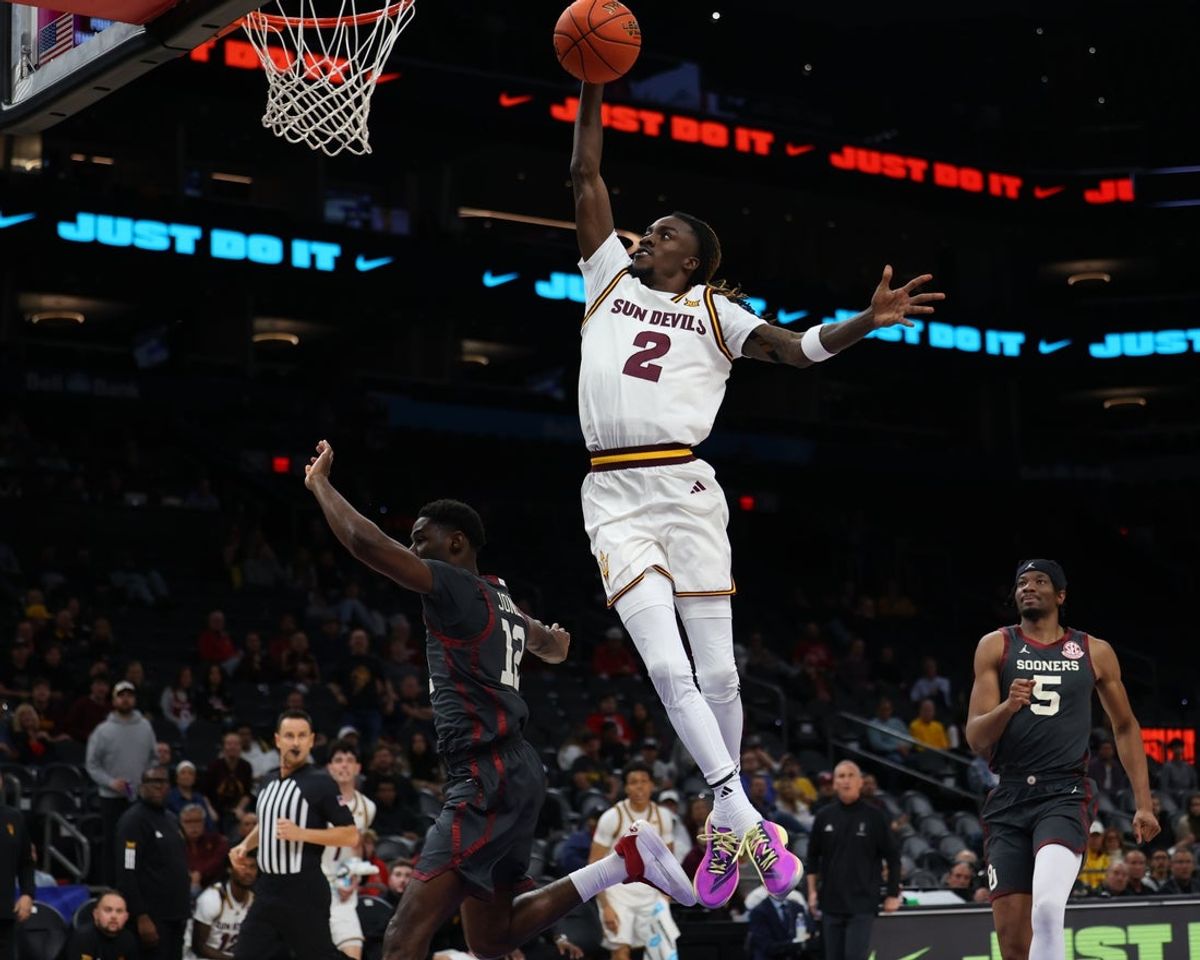 Dec 6, 2025; Phoenix, Arizona, USA; Arizona State University Sun Devils guard Anthony Johnson (2) dunks over Oklahoma University Sooners guard Jadon Jones (12) in the second half at PHX Arena. Mandatory Credit: Anna Carrington-Imagn Images