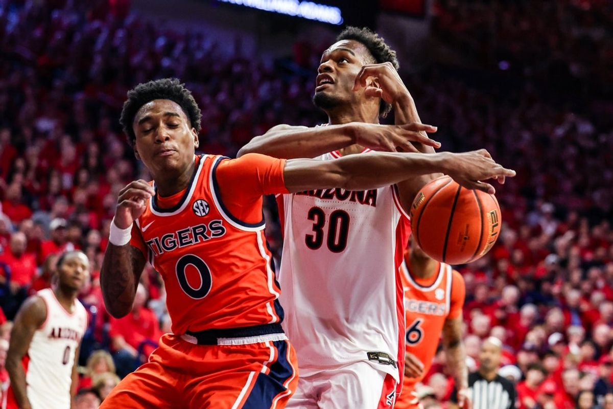 Dec 6, 2025; Tucson, Arizona, USA; Auburn Tigers guard Tahaad Pettiford (0) hits the ball out of the hands of Arizona Wildcats forward Tobe Awaka (30) during the second half of the game at McKale Memorial Center. Mandatory Credit: Aryanna Frank-Imagn Images