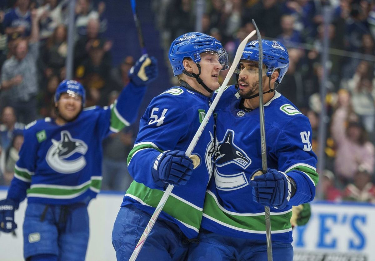 Dec 6, 2025; Vancouver, British Columbia, CAN; Vancouver Canucks center Aatu Raty (54) celebrates his goal with Vancouver Canucks left wing Evander Kane (91) against the Minnesota Wild in the third period  at Rogers Arena. Mandatory Credit: Christopher Morris-Imagn Images