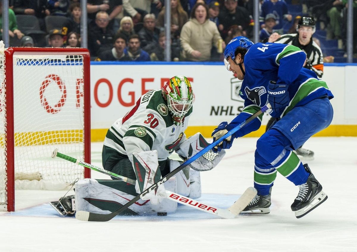 Dec 6, 2025; Vancouver, British Columbia, CAN; Vancouver Canucks left wing Kiefer Sherwood (44) is stopped on a breakaway against Minnesota Wild goalie Jesper Wallstedt (30) at Rogers Arena. Mandatory Credit: Christopher Morris-Imagn Images
