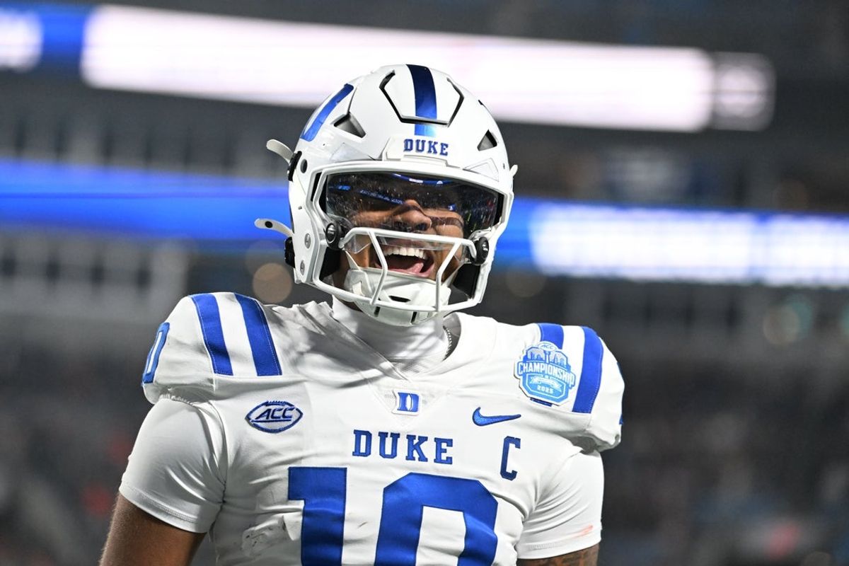Dec 6, 2025; Charlotte, NC, USA; Duke Blue Devils quarterback Darian Mensah (10) celebrates after the Blue Devils score a touchdown in overtime during the  ACC Championship game at Bank of America Stadium. Mandatory Credit: Bob Donnan-Imagn Images