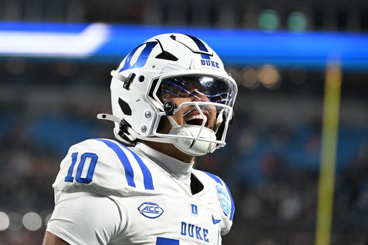 Dec 6, 2025; Charlotte, NC, USA; Duke Blue Devils quarterback Darian Mensah (10) celebrates after the Blue Devils score a touchdown in overtime during the  ACC Championship game at Bank of America Stadium. Mandatory Credit: Bob Donnan-Imagn Images