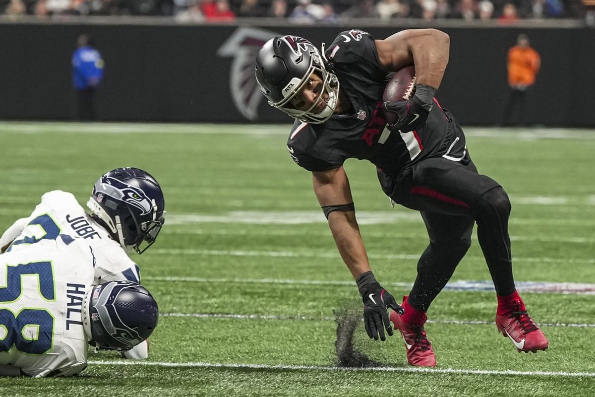 Dec 7, 2025; Atlanta, Georgia, USA; Atlanta Falcons running back Bijan Robinson (7) runs against Seattle Seahawks cornerback Josh Jobe (29) and linebacker Derick Hall (58) during the first quarter at Mercedes-Benz Stadium. Mandatory Credit: Dale Zanine-Imagn Images
