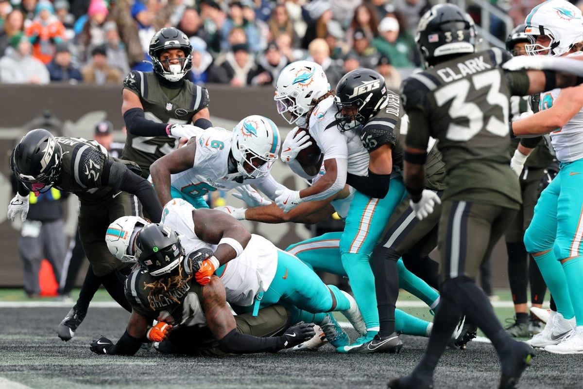 Dec 7, 2025; East Rutherford, New Jersey, USA; Miami Dolphins running back Jaylen Wright (5) scores a touchdown against the New York Jets during the first half at MetLife Stadium. Mandatory Credit: Ed Mulholland-Imagn Images