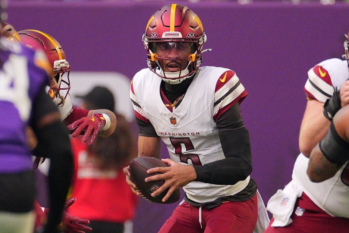 Dec 7, 2025; Minneapolis, Minnesota, USA; Washington Commanders quarterback Jayden Daniels (5) drops back to pass against the Minnesota Vikings during the first half at U.S. Bank Stadium. Mandatory Credit: Brad Rempel-Imagn Images