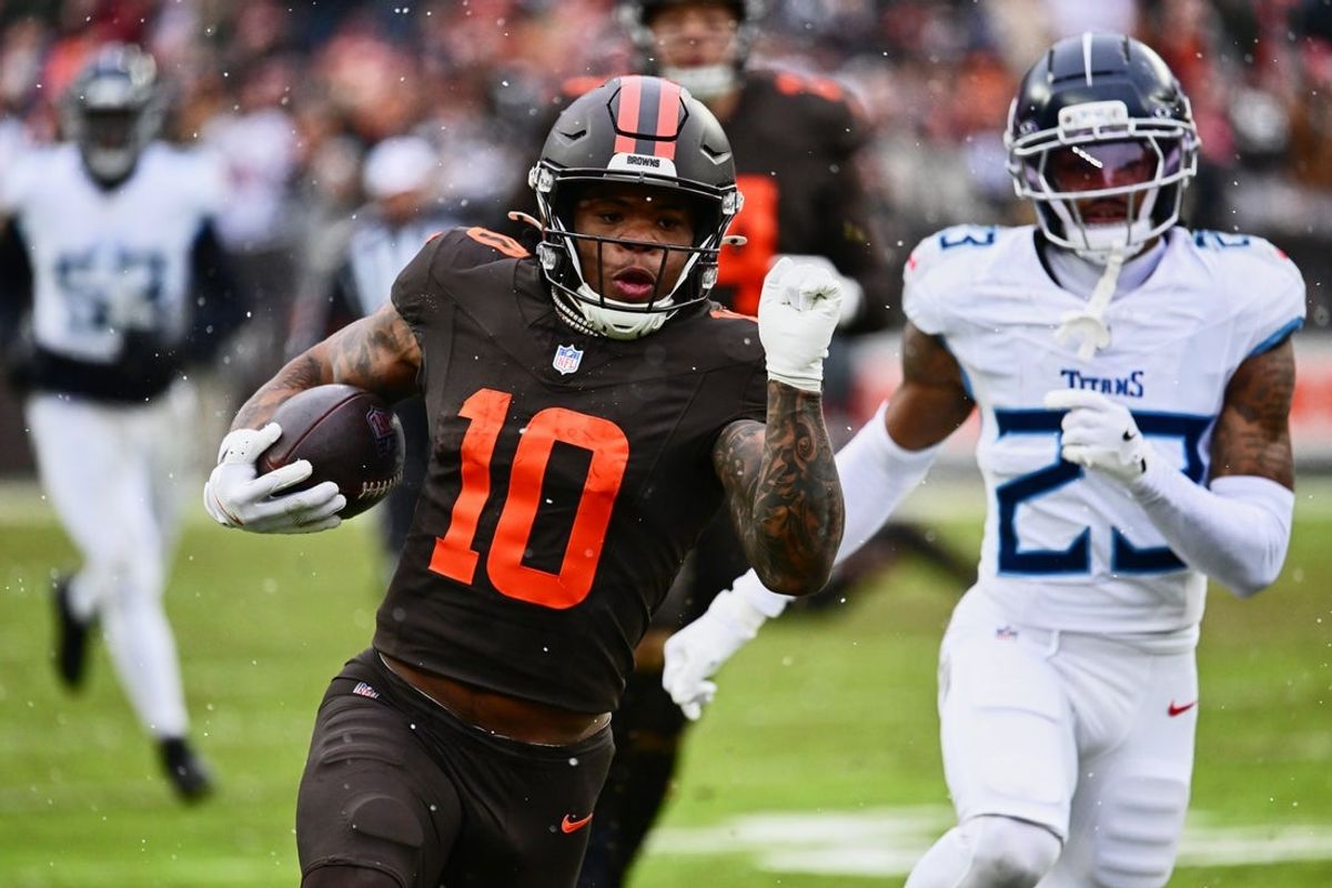 Dec 7, 2025; Cleveland, Ohio, USA; Cleveland Browns running back Quinshon Judkins (10) runs with the ball against Tennessee Titans safety Kevin Winston Jr. (23) during the first quarter at Huntington Bank Field. Mandatory Credit: Ken Blaze-Imagn Images