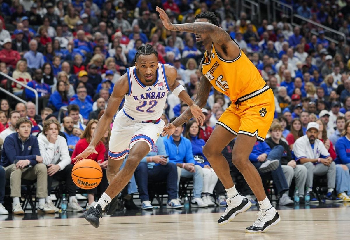 Dec 7, 2025; Kansas City, Missouri, USA; Kansas Jayhawks guard Darryn Peterson (22) drives against Missouri Tigers center Shawn Phillips Jr. (15) during the first half at T-Mobile Center. Mandatory Credit: Jay Biggerstaff-Imagn Images