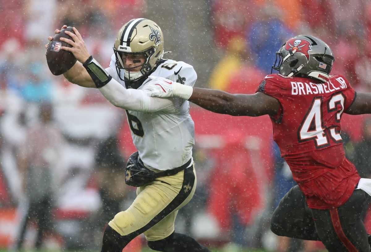 Dec 7, 2025; Tampa, Florida, USA; New Orleans Saints quarterback Tyler Shough (6) scrambles in the pocket under pressure from Tampa Bay Buccaneers linebacker Chris Braswell (43) during the second quarter at Raymond James Stadium. Mandatory Credit: Nathan Ray Seebeck-Imagn Images