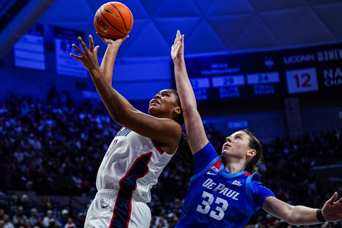 Dec 7, 2025; Storrs, Connecticut, USA; UConn Huskies forward Sarah Strong (21) shoots the ball against DePaul Blue Demons guard Kate Novik (33) in the second half at Harry A. Gampel Pavilion. Mandatory Credit: David Butler II-Imagn Images