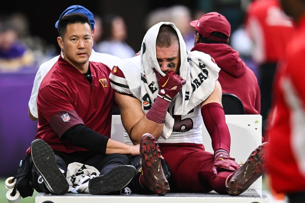 Dec 7, 2025; Minneapolis, Minnesota, USA; Washington Commanders tight end Zach Ertz (86) is carted off the field after an injury during the second half at U.S. Bank Stadium. Mandatory Credit: Jeffrey Becker-Imagn Images