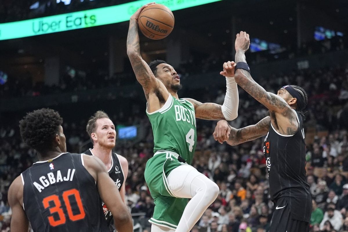 Dec 7, 2025; Toronto, Ontario, CAN; Boston Celtics guard Anfernee Simons (4) goes up to make a basket against Toronto Raptors forward Brandon Ingram (3) during the first half at Scotiabank Arena. Mandatory Credit: John E. Sokolowski-Imagn Images