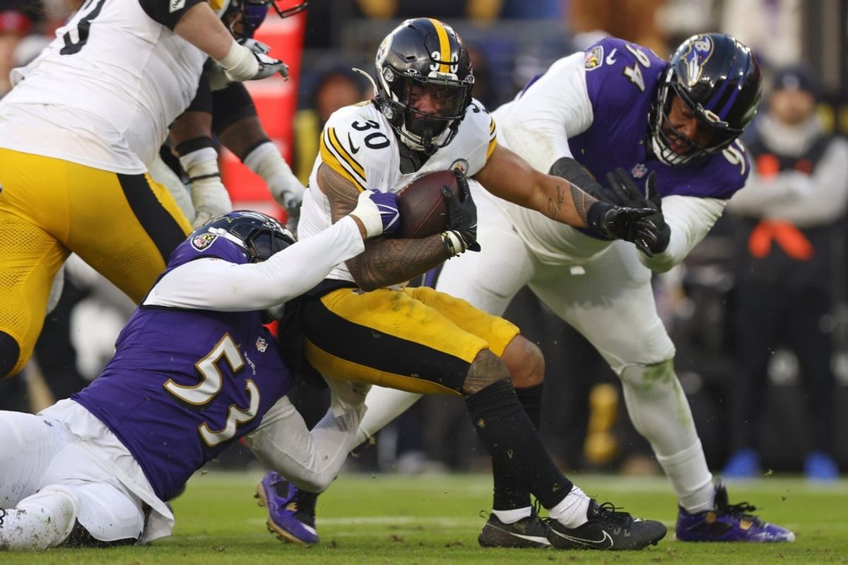 Dec 7, 2025; Baltimore, Maryland, USA; Baltimore Ravens linebacker Kyle Van Noy (53) tackles Pittsburgh Steelers running back Jaylen Warren (30) during the second half at M&T Bank Stadium. Mandatory Credit: Peter Casey-Imagn Images