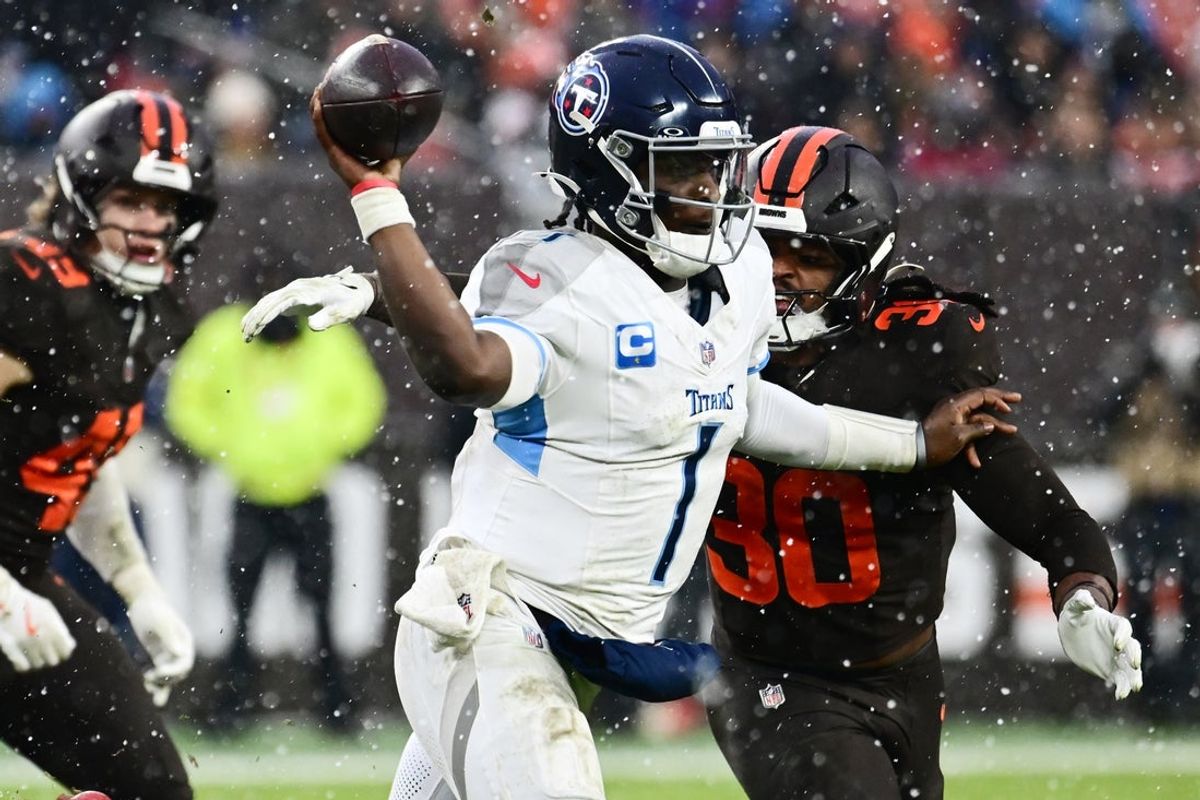 Dec 7, 2025; Cleveland, Ohio, USA; Tennessee Titans quarterback Cam Ward (1) throws a pass as Cleveland Browns linebacker Devin Bush (30) rushes during the fourth quarter at Huntington Bank Field. Mandatory Credit: Ken Blaze-Imagn Images