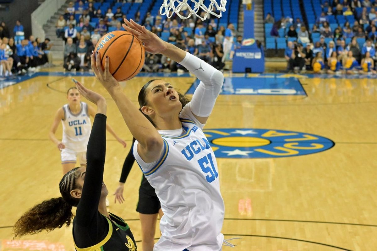 Dec 7, 2025; Los Angeles, California, USA;  UCLA Bruins center Lauren Betts (51) drives past Oregon Ducks forward Sarah Rambus (23) for a basket during the first half at Pauley Pavilion presented by Wescom Financial. Mandatory Credit: Jayne Kamin-Oncea-Imagn Images