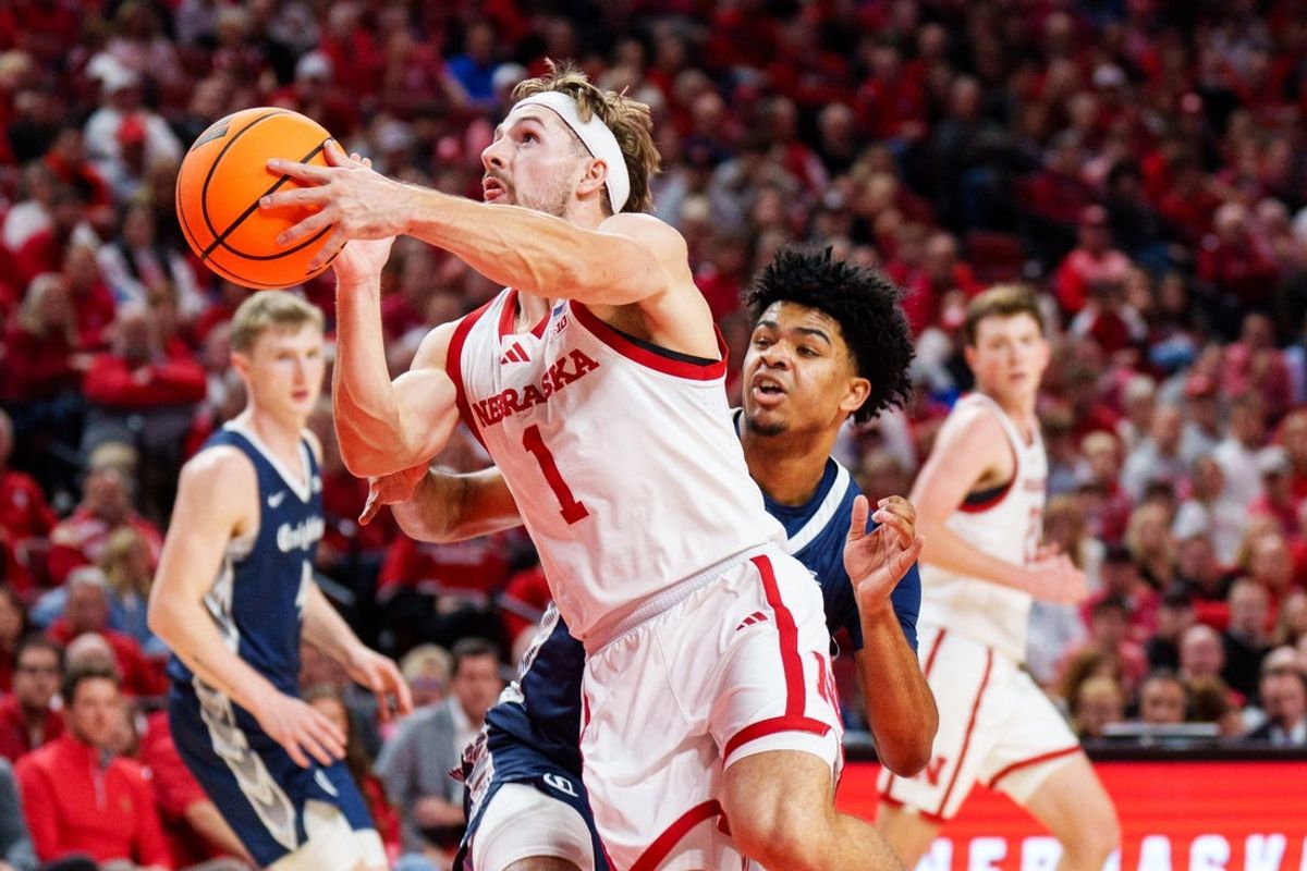 Dec 7, 2025; Lincoln, Nebraska, USA; Nebraska Cornhuskers guard Sam Hoiberg (1) shoots the ball against Creighton Bluejays guard Austin Swartz (1) during the first half at Pinnacle Bank Arena. Mandatory Credit: Dylan Widger-Imagn Images