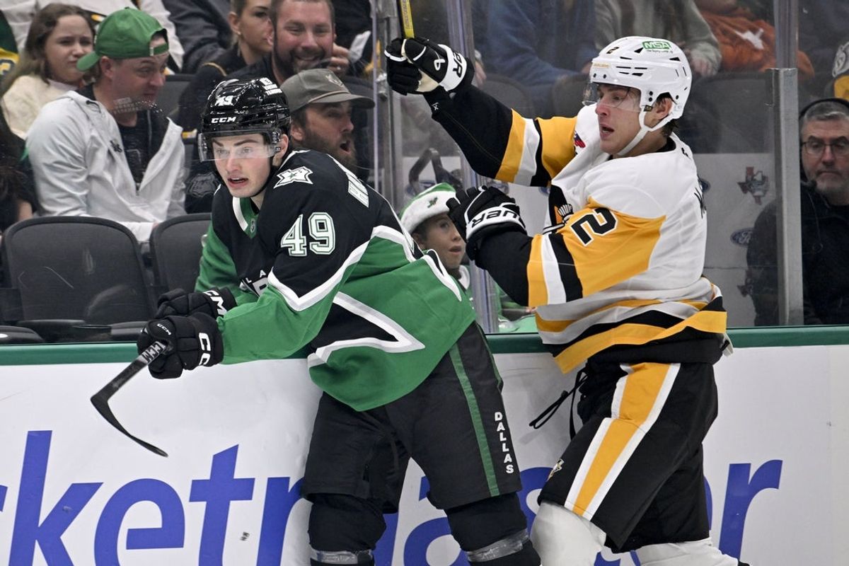 Dec 7, 2025; Dallas, Texas, USA; Dallas Stars center Justin Hryckowian (49) and Pittsburgh Penguins right wing Rutger McGroarty (2) chase the puck during the first period at American Airlines Center. Mandatory Credit: Jerome Miron-Imagn Images