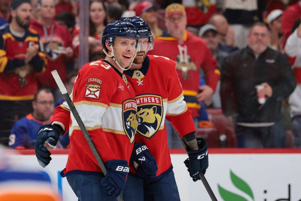 Dec 7, 2025; Sunrise, Florida, USA; Florida Panthers center Carter Verhaeghe (23) celebrates with defenseman Jeff Petry (2) after scoring against the New York Islanders during the second period at Amerant Bank Arena. Mandatory Credit: Sam Navarro-Imagn Images