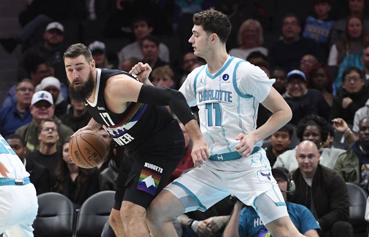 Dec 7, 2025; Charlotte, North Carolina, USA; Denver Nuggets center Jonas Valanciunas (17) looks to drive past Charlotte Hornets center Ryan Kalkbrenner (11) during the first half at the Spectrum Center. Mandatory Credit: Sam Sharpe-Imagn Images
