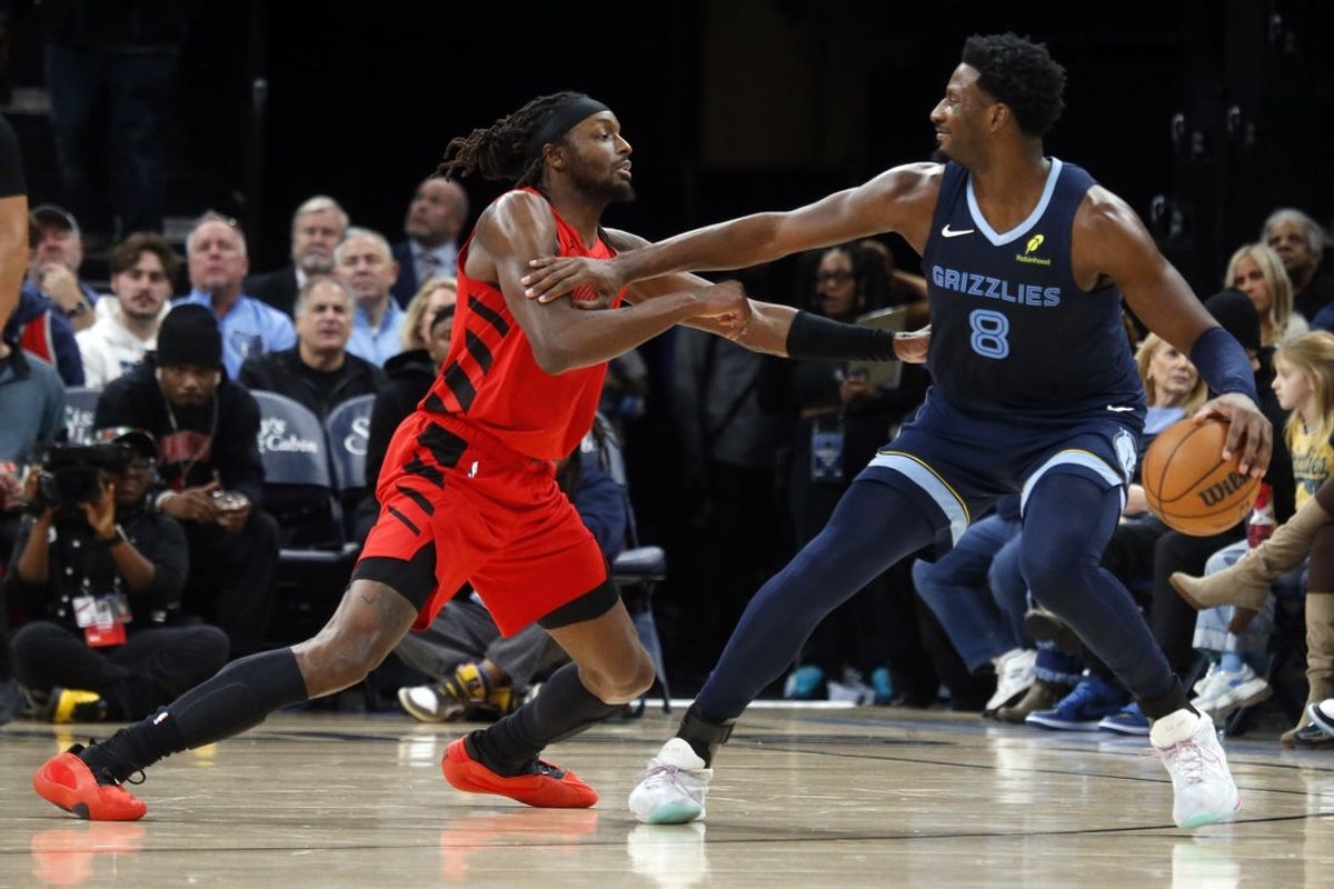 Dec 7, 2025; Memphis, Tennessee, USA; Memphis Grizzlies forward/center Jaren Jackson Jr. (8) dribbles as Portland Trail Blazers forward Jerami Grant (9) defends during the second quarter at FedExForum. Mandatory Credit: Petre Thomas-Imagn Images