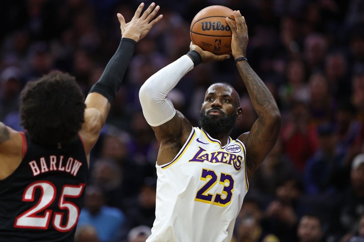 Dec 7, 2025; Philadelphia, Pennsylvania, USA; Los Angeles Lakers forward Lebron James (23) shoots past Philadelphia 76ers forward Dominick Barlow (25) during the first quarter at Xfinity Mobile Arena. Mandatory Credit: Bill Streicher-Imagn Images