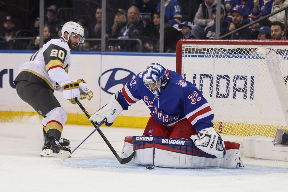 Dec 7, 2025; New York, New York, USA;  New York Rangers goaltender Jonathan Quick (32) makes a save on a shot on goal attempt from Vegas Golden Knights left wing Brandon Saad (20) in the second period at Madison Square Garden. Mandatory Credit: Wendell Cruz-Imagn Images