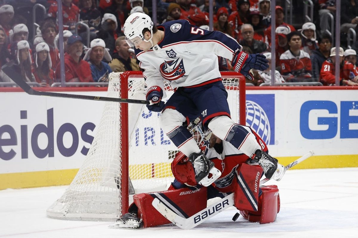 Dec 7, 2025; Washington, District of Columbia, USA; Washington Capitals goaltender Logan Thompson (48) makes a save while being run into by Columbus Blue Jackets defenseman Denton Mateychuk (5) during the second period at Capital One Arena. Mandatory Credit: Geoff Burke-Imagn Images
