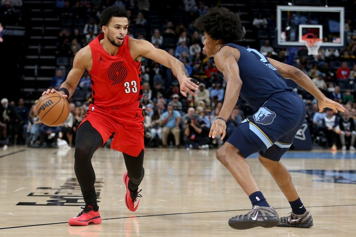 Dec 7, 2025; Memphis, Tennessee, USA; Portland Trail Blazers forward Toumani Camara (33) drives to the basket as Memphis Grizzlies forward Jaylen Wells (0) defends during the first quarter at FedExForum. Mandatory Credit: Petre Thomas-Imagn Images