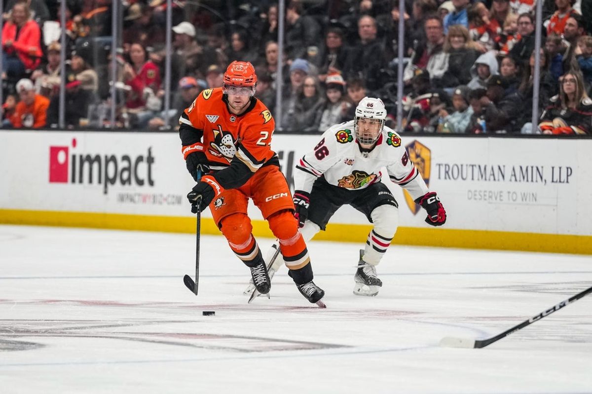 Dec 7, 2025; Anaheim, California, USA; Anaheim Ducks center Ryan Poehling (25) skates with puck against Chicago Blackhawks center Teuvo Teravainen (86) at Honda Center. Mandatory Credit: Corinne Votaw-Imagn Images