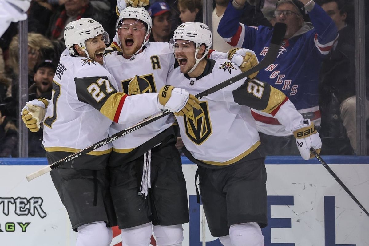 Dec 7, 2025; New York, New York, USA;  Vegas Golden Knights center Jack Eichel (9) celebrates with defenseman Shea Theodore (27) and center Brett Howden (21) after scoring the game winning goal in overtime to defeat the New York Rangers 3-2 at Madison Square Garden. Mandatory Credit: Wendell Cruz-Imagn Images