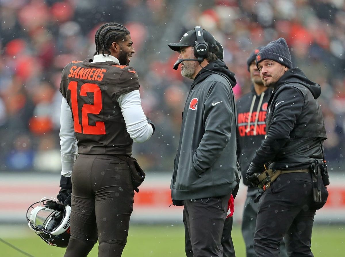 Cleveland Browns quarterback Shedeur Sanders (12) talks with coach Kevin Stefanski during a game against the Tennessee Titans on Dec. 7, 2025, in Cleveland.