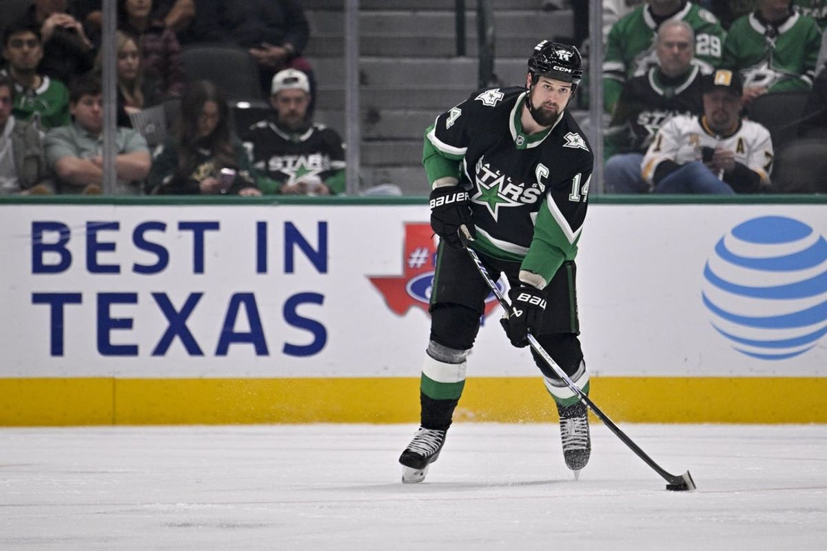 Dec 7, 2025; Dallas, Texas, USA; Dallas Stars left wing Jamie Benn (14) looks to pass the puck during the second period against the Pittsburgh Penguins at American Airlines Center. Mandatory Credit: Jerome Miron-Imagn Images