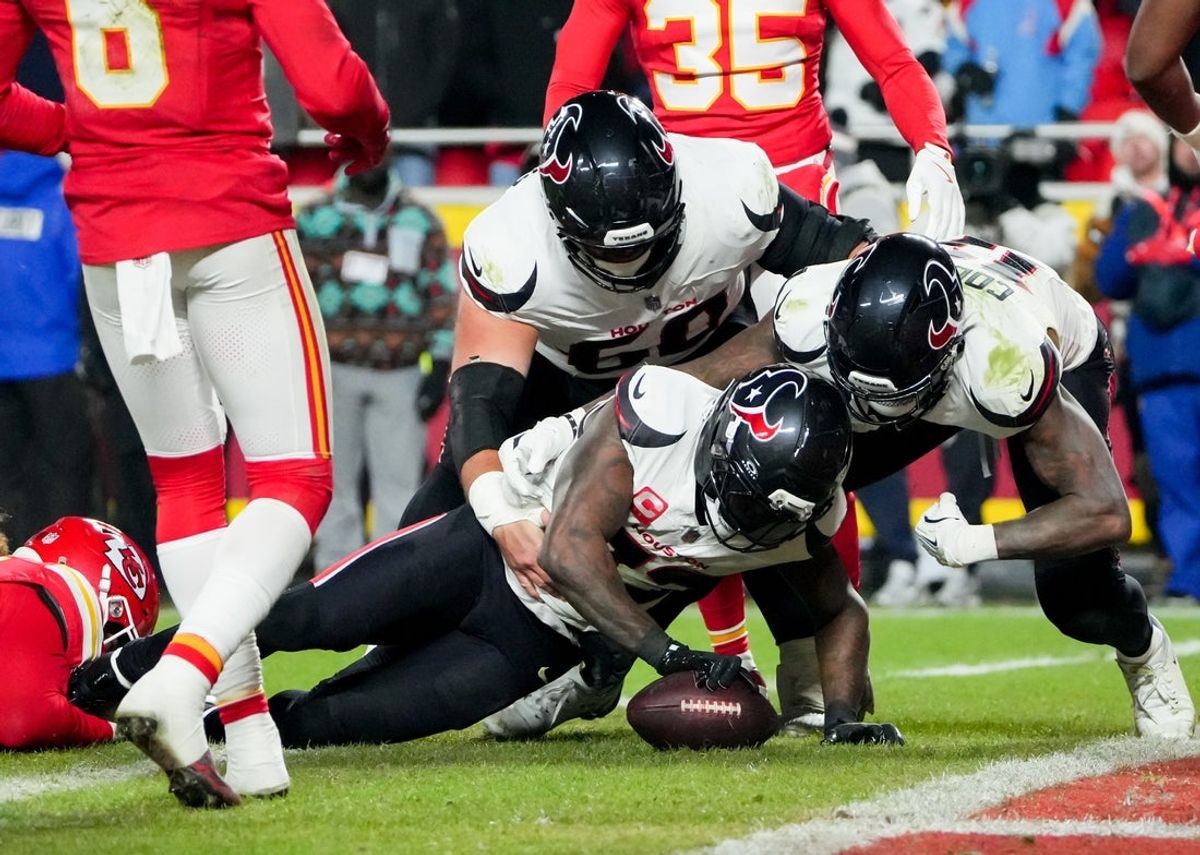 Dec 7, 2025; Kansas City, Missouri, USA; Houston Texans running back Dare Ogunbowale (33) scores a touchdown during the fourth quarter against the Kansas City Chiefs at GEHA Field at Arrowhead Stadium. Mandatory Credit: Denny Medley-Imagn Images