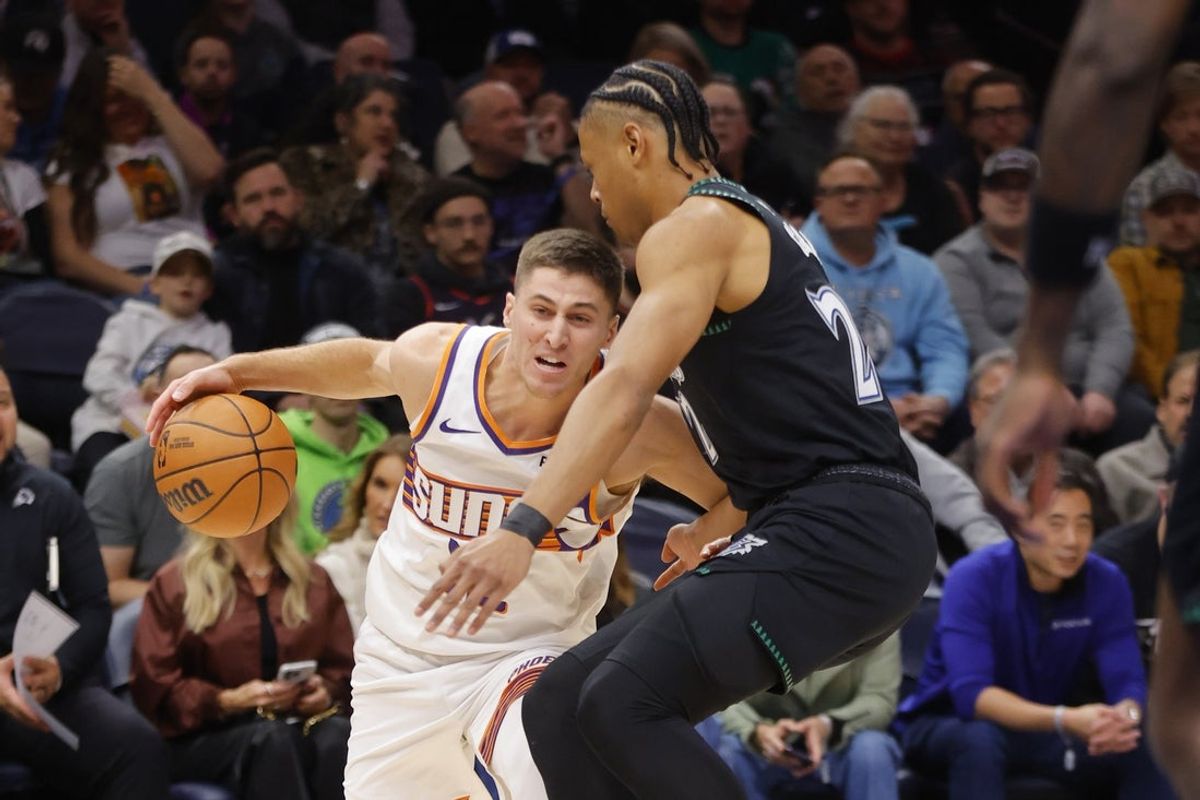 Dec 8, 2025; Minneapolis, Minnesota, USA; Phoenix Suns guard Collin Gillespie (12) works around Minnesota Timberwolves guard Jaylen Clark (22) in the first quarter at Target Center. Mandatory Credit: Bruce Kluckhohn-Imagn Images