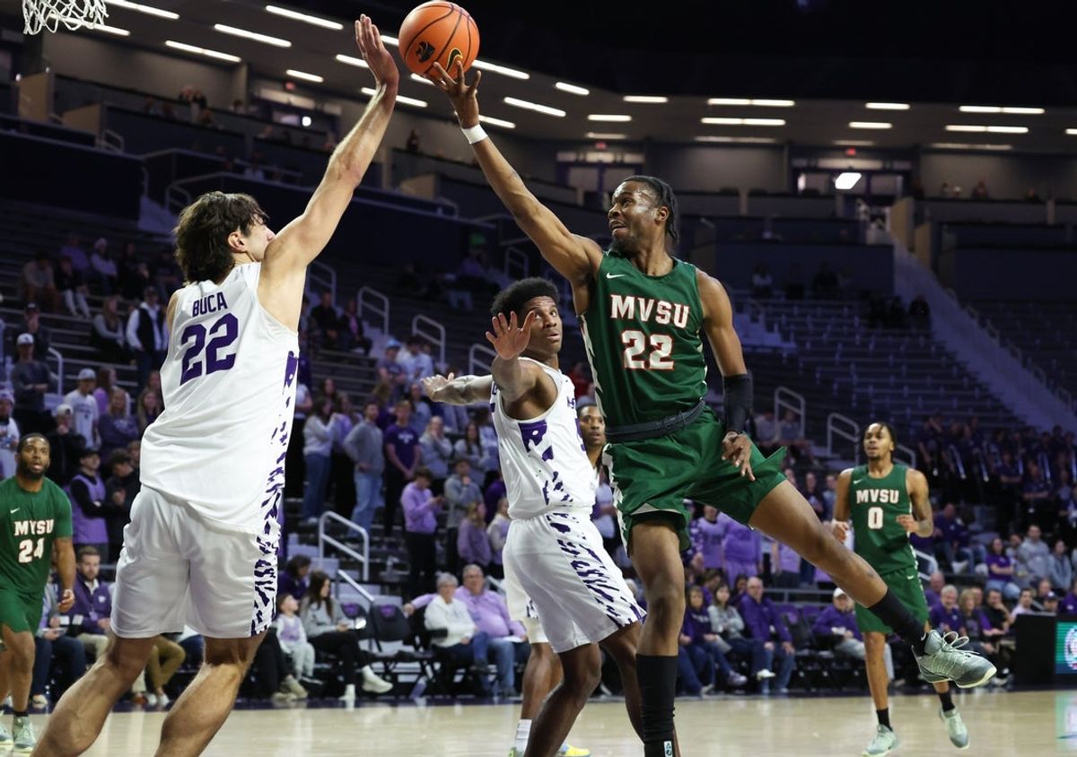 Dec 8, 2025; Manhattan, Kansas, USA; Mississippi Valley State Delta Devils forward Daniel Mayfield (22) shoots against Kansas State Wildcats center Dorin Buca (22) during the first half at Bramlage Coliseum. Mandatory Credit: Scott Sewell-Imagn Images