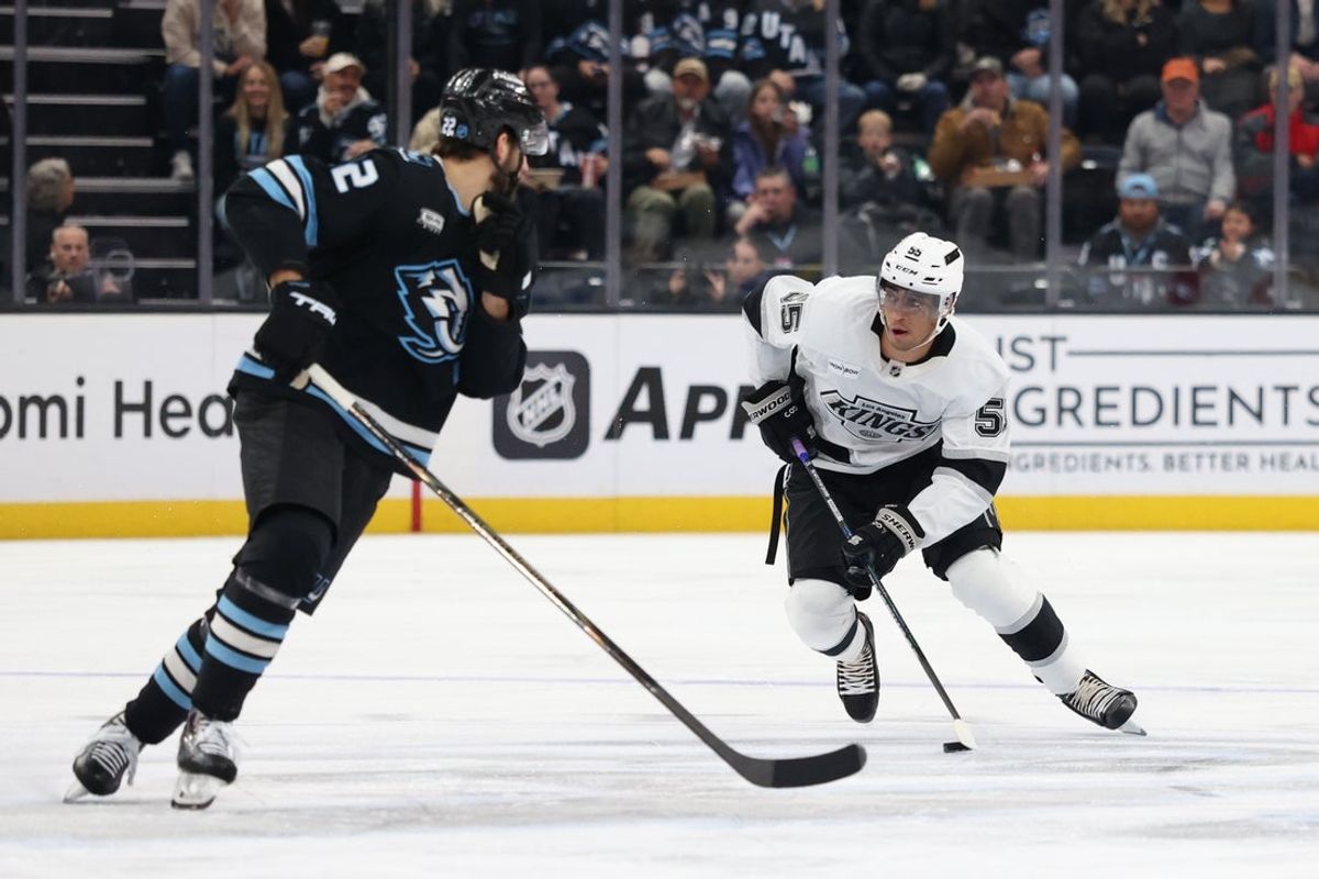 Dec 8, 2025; Salt Lake City, Utah, USA; Los Angeles Kings right wing Quinton Byfield (55) advances the puck against Utah Mammoth center Jack McBain (22) during the first period at Delta Center. Mandatory Credit: Rob Gray-Imagn Images