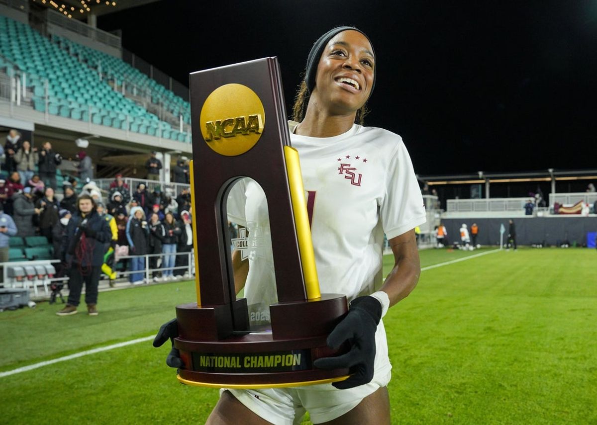 Dec 8, 2025; Kansas City, MO, USA; Florida State Seminoles forward Jordynn Dudley (11) celebrates with the trophy after defeating the Stanford Cardinal to win the 2025 NCAA Women’s Soccer College Cup Championship at CPKC Stadium. Mandatory Credit: Jay Biggerstaff-Imagn Images
