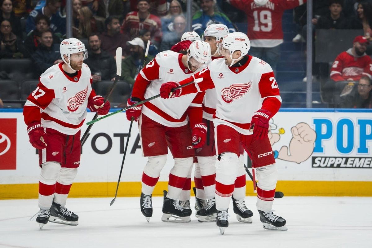 Dec 8, 2025; Vancouver, British Columbia, CAN; Detroit Red Wings defenseman Ben Chiarot (8) and forward Michael Rasmussen (27) and forward J.T. Compher (37) and forward James van Riemsdyk (21) celebrate Riemsdyk’s goal against the Vancouver Canucks in the first period at Rogers Arena. Mandatory Credit: Bob Frid-Imagn Images