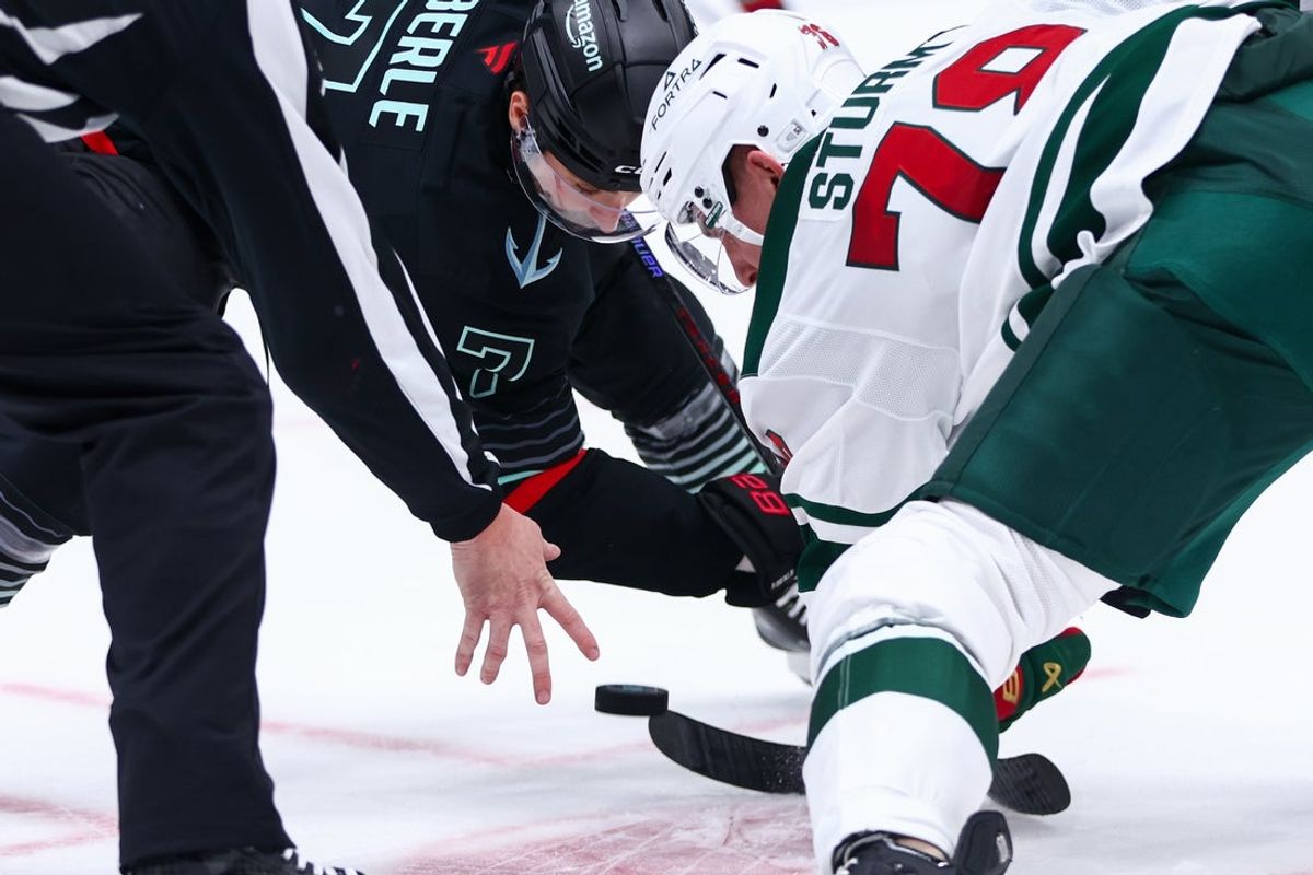 Dec 8, 2025; Seattle, Washington, USA; Seattle Kraken right wing Jordan Eberle (7) and Minnesota Wild center Nico Sturm (78) battle for the puck in the second period at Climate Pledge Arena. Mandatory Credit: Kevin Ng-Imagn Images