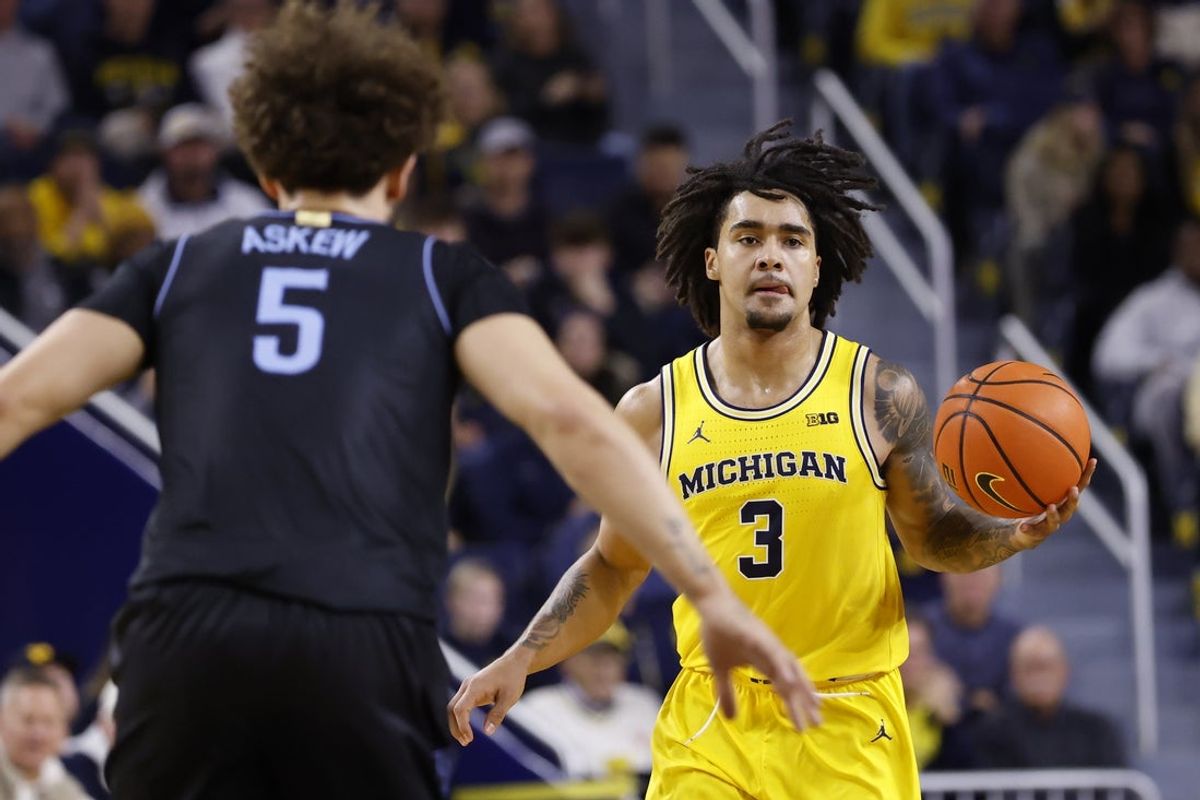 Dec 9, 2025; Ann Arbor, Michigan, USA;  Michigan Wolverines guard Elliot Cadeau (3) dribbles defended by Villanova Wildcats guard Devin Askew (5) in the first half at Crisler Center. Mandatory Credit: Rick Osentoski-Imagn Images