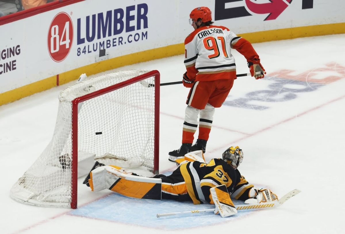 Dec 9, 2025; Pittsburgh, Pennsylvania, USA;  Anaheim Ducks center Leo Carlsson (91) scores the game winning goal against Pittsburgh Penguins goaltender Arturs Silovs (37) in a shootout at PPG Paints Arena. Mandatory Credit: Charles LeClaire-Imagn Images