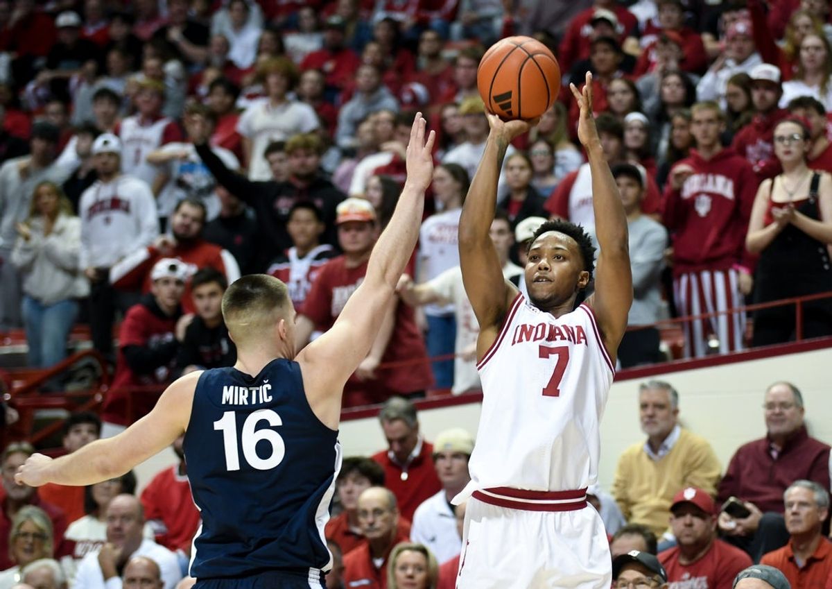 Dec 9, 2025; Bloomington, Indiana, USA; Indiana Hoosiers forward Nick Dorn (7) shoots the ball over Penn State Nittany Lions forward Tibor Mirtic (16) during the first half at Simon Skjodt Assembly Hall. Mandatory Credit: Robert Goddin-Imagn Images