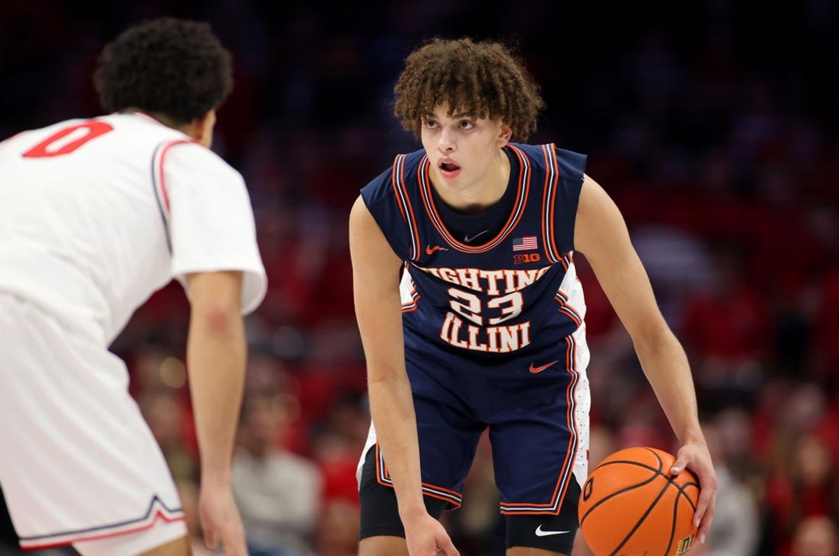 Dec 9, 2025; Columbus, Ohio, USA; Illinois Fighting Illini guard Keaton Wagler (23) handles the ball as Ohio State Buckeyes guard John Mobley Jr. (0) defends during the first halfat Value City Arena. Mandatory Credit: Joseph Maiorana-Imagn Images