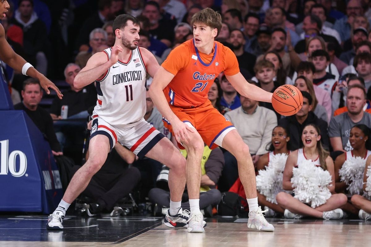Dec 9, 2025; New York, New York, USA;  Florida Gators forward Alex Condon (21) looks to post up against UConn Huskies forward Alex Karaban (11) in the first half at Madison Square Garden. Mandatory Credit: Wendell Cruz-Imagn Images