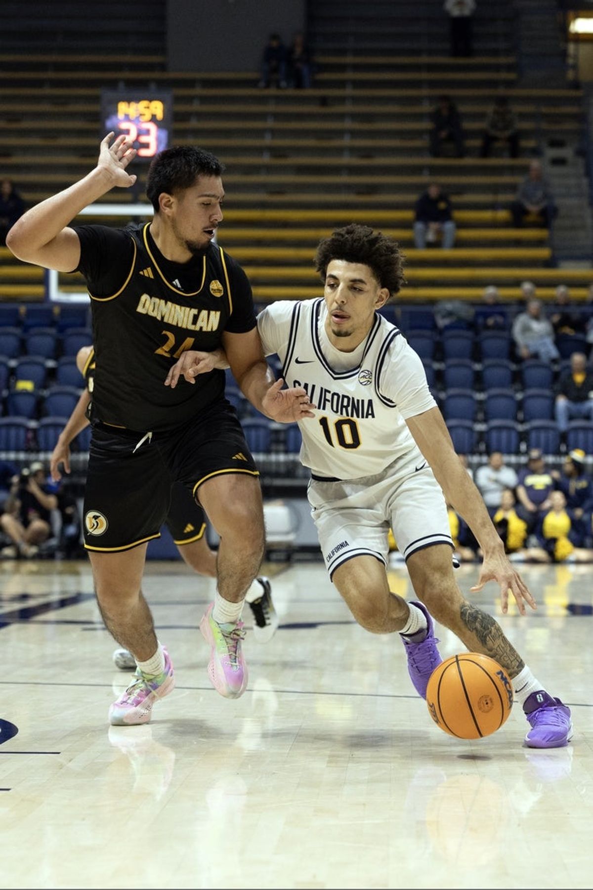 Dec 9, 2025; Berkeley, California, USA; California Golden Bears guard Justin Pippen (10) dribbles the ball past Dominican Penguins forward Jorge Ochoa (24) during the first half at Haas Pavilion. Mandatory Credit: D. Ross Cameron-Imagn Images