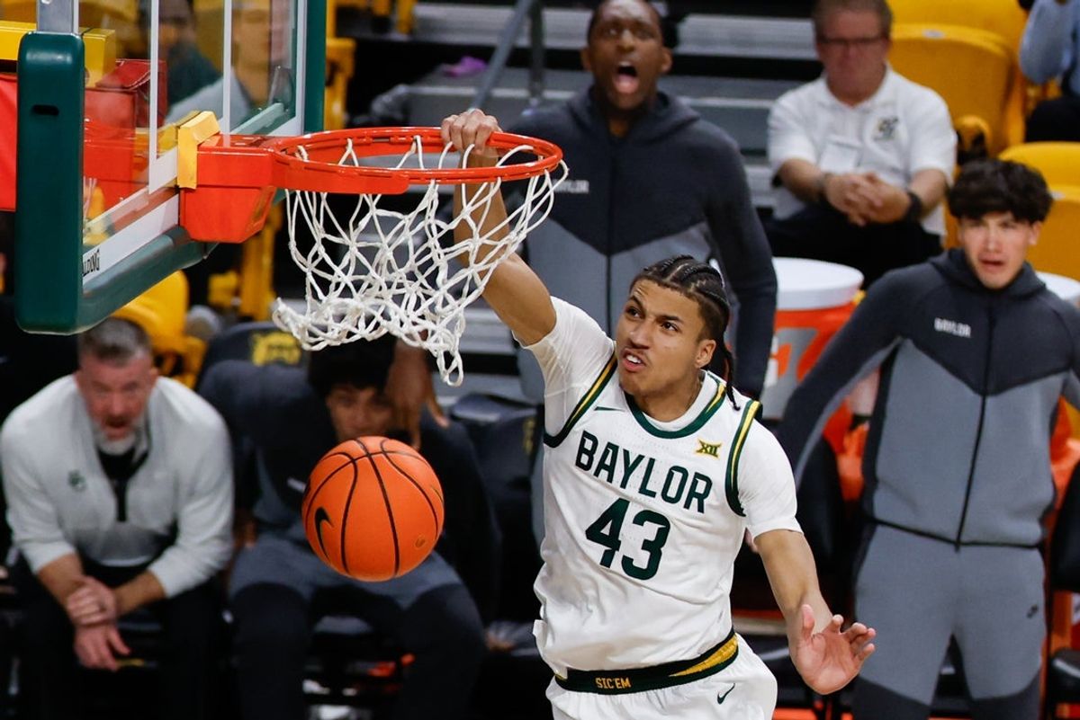 Dec 10, 2025; Waco, Texas, USA;  Baylor Bears guard Cameron Carr (43) dunks the ball against Norfolk State Spartans guard Elijah Jamison (2) during the second half at Paul and Alejandra Foster Pavilion. Mandatory Credit: Chris Jones-Imagn Images