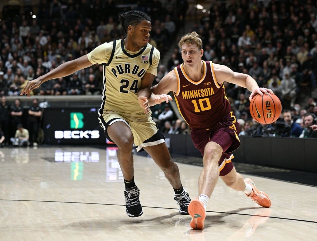 Dec 10, 2025; West Lafayette, Indiana, USA; Minnesota Golden Gophers forward Cade Tyson (10) drives down court against Purdue Boilermakers guard Jack Benter (14) during the first half  at Mackey Arena. Mandatory Credit: Marc Lebryk-Imagn Images