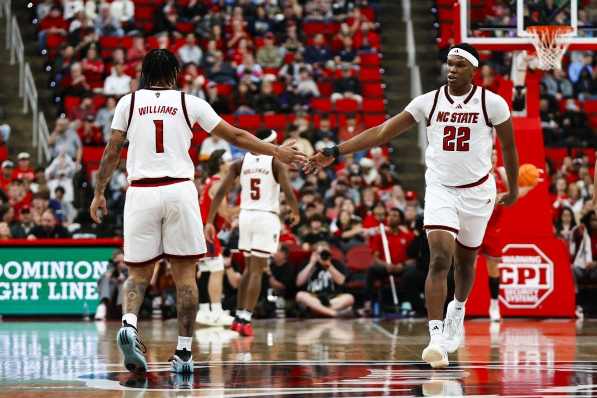 Dec 6, 2025; Raleigh, North Carolina, USA; NC State Wolfpack forward Darrion Williams (1) and forward Ven-Allen Lubin (22) high five during the second half of the game against the Liberty Flames at Lenovo Center. Mandatory Credit: Jaylynn Nash-Imagn Images