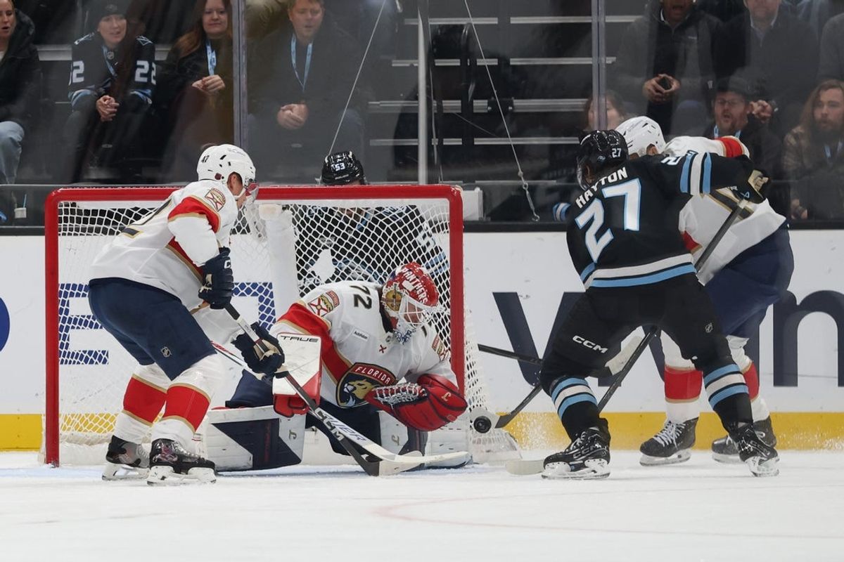 Dec 10, 2025; Salt Lake City, Utah, USA; Utah Mammoth center Barrett Hayton (27) plays the puck against Florida Panthers goaltender Sergei Bobrovsky (72) during the first period at Delta Center. Mandatory Credit: Rob Gray-Imagn Images