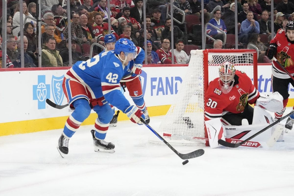 Dec 10, 2025; Chicago, Illinois, USA; New York Rangers center Noah Laba (42) looks to shoot the puck on Chicago Blackhawks goaltender Spencer Knight (30) during the third period at United Center. Mandatory Credit: David Banks-Imagn Images