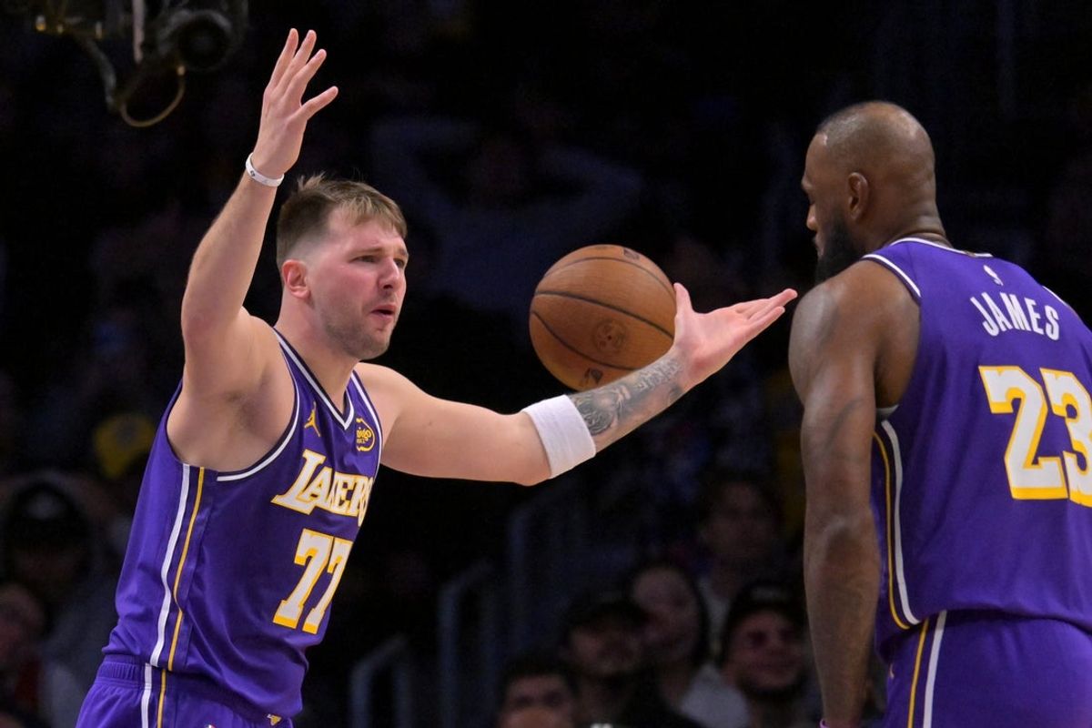 Dec 10, 2025; Los Angeles, California, USA;  Los Angeles Lakers guard Luka Doncic (77) and forward Lebron James (23) react after a foul call during the second half against the San Antonio Spurs at Crypto.com Arena. Mandatory Credit: Jayne Kamin-Oncea-Imagn Images